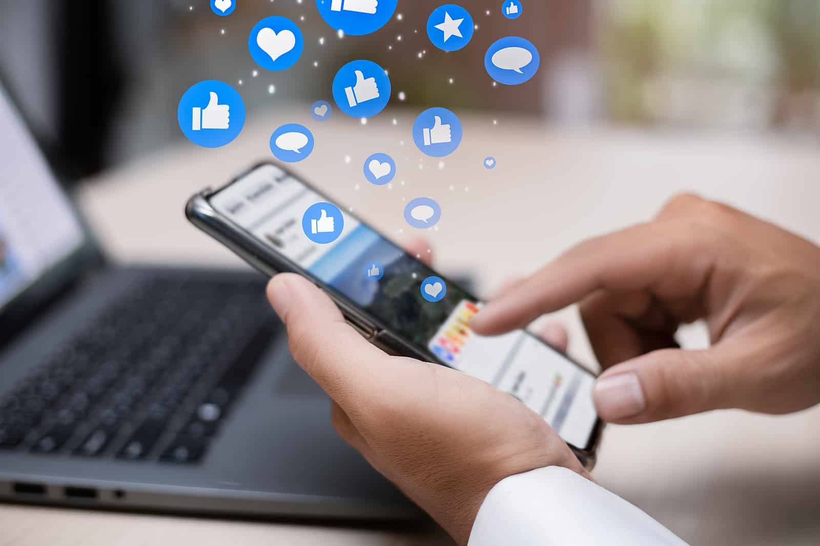 Man person hands holding smartphone for social interaction on social media with notification icons like, heart, comment message and star, digital marketing and social media concept.